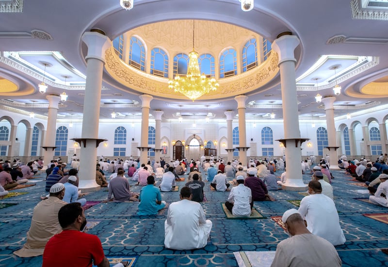 Worshippers sit to pray at the mosque on Electra Street in Abu Dhabi.