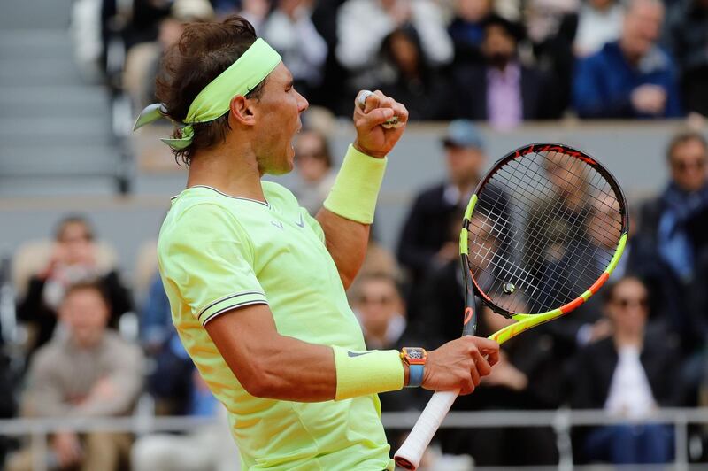 Nadal reacts after winning a point against Federer. AFP