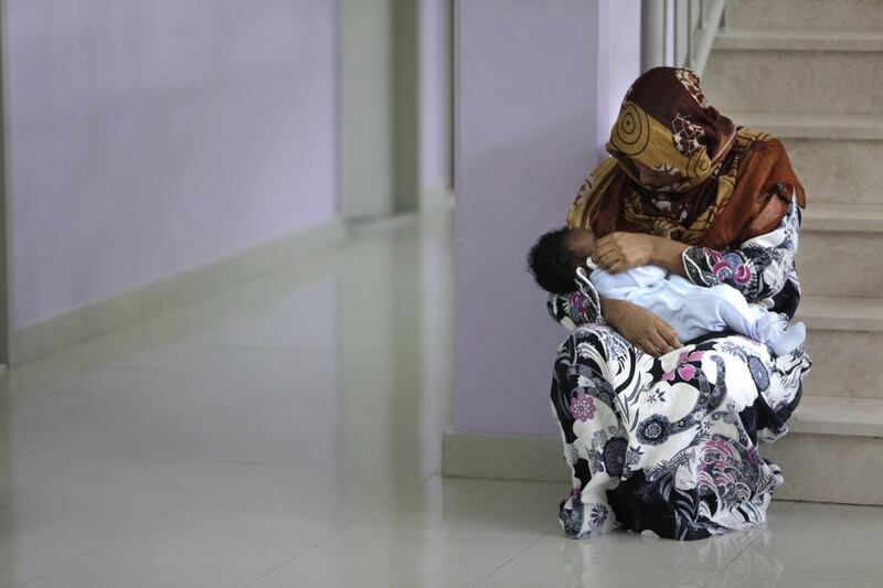 The nannies, dressed in white uniforms, care for children whose mothers are attending court or have a doctor’s appointment.