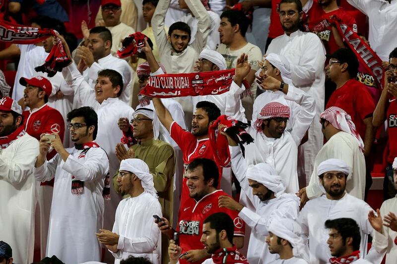 Al Ahli fans celebrate after their club's victory on Sunday. Satish Kumar / The National