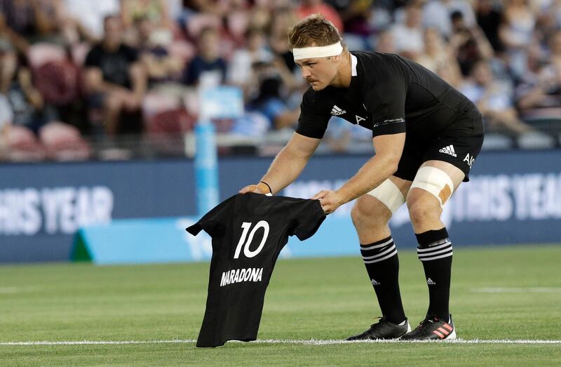 New Zealand captain Sam Cane lays an All Black No 10 jersey on the pitch in memory of late Argentina football star Diego Maradona. AP