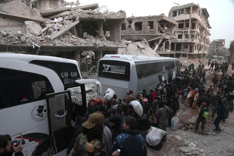 Syrians gather to board busses as they prepare to evacuate one of the few remaining rebel-held pockets in Arbin, in Eastern Ghouta, on the outskirts of the Syrian capital Damascus, on March 24, 2018.
Syrian rebels and civilians prepared to evacuate the penultimate opposition-held pocket of Eastern Ghouta, as the government moved ever closer to securing the outskirts of the capital. / AFP PHOTO / ABDULMONAM EASSA