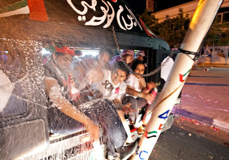 Ras al Khaimah, December 2, 2011 - Children riding in a Hummer limousine are sprayed with silly string during National Day celebrations on the Corniche in Ras al Khaimah City, Ras al Khaimah, December 2, 2011. (Jeff Topping/The National)