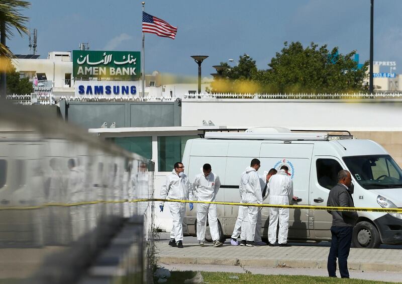 Police and forensic experts inspect the scene of an explosion near the US embassy in the Tunisian capital Tunis. AFP