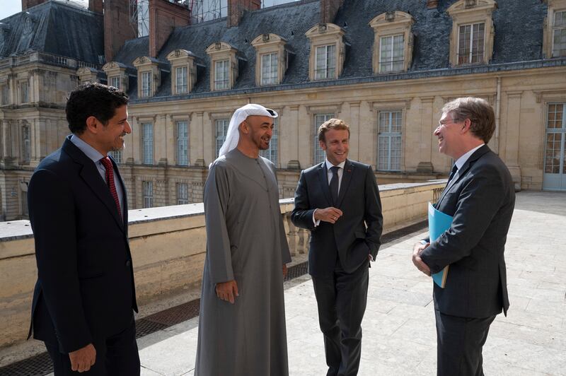 Sheikh Mohamed is received by President Macron, third from left, at the palace. To their left is Ali bin Hammad Al Shamsi, Deputy Secretary General of the UAE Supreme National Security Council.