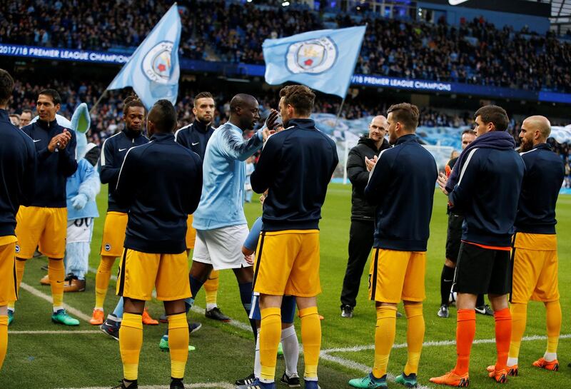 Manchester City's Yaya Toure walks out to a guard of honour before the match. Andrew Yates / Reuters