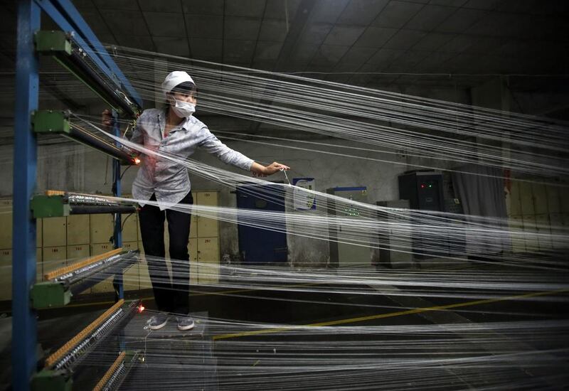 An employee works at a textile factory in Wuhan, Hubei province. Activity in China's factories increased marginally in April but export orders fell sharply, a government survey showed. Reuters