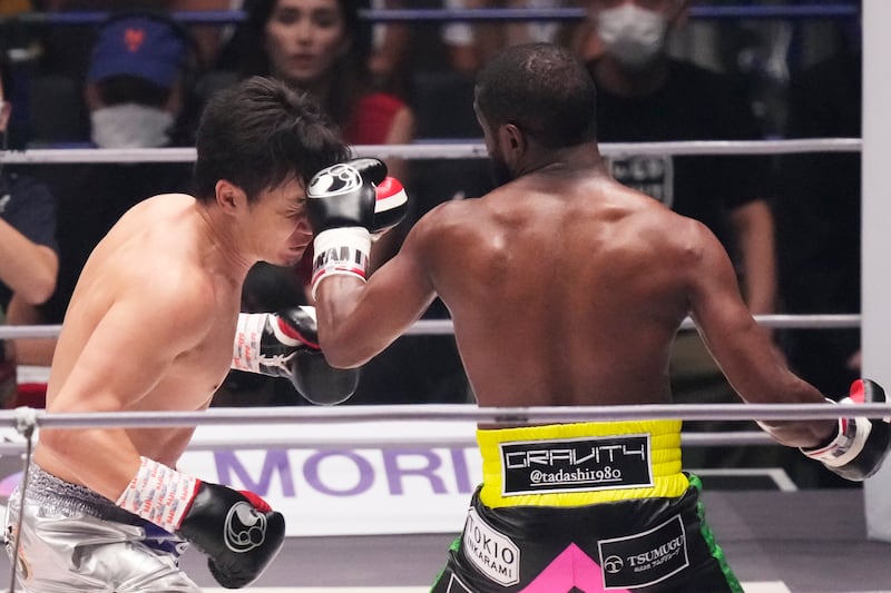 Floyd Mayweather throws a punch at Mikuru Asakura. AP