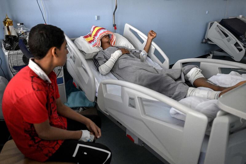 Youssef, 18, a survivor of the flooding, lies on a bed at the Benghazi Medical Centre hospital. AFP