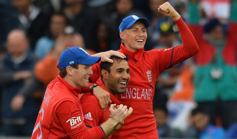 England's Ravi Bopara (C) celebrates the dismissal of Indian captain Mahendra Sing Dhoni with teammates Joe Root (R) and Eoin Morgan during the 2013 ICC Champions Trophy Final cricket match between England and India at Edgbaston in Birmingham, central England on 23, June 2013.  Play in the rain-marred Champions Trophy final between hosts England and world champions India at Edgbaston got underway nearly six hours late. Rain reduced the showpiece match from a 50 overs per side contest to the bare minimum of 20 overs per side required to produced a result, with the fixture, due to get underway at 10.30am local time (0930GMT) finally starting at 4:20pm. AFP PHOTO/PAUL ELLIS
 *** Local Caption ***  408392-01-08.jpg