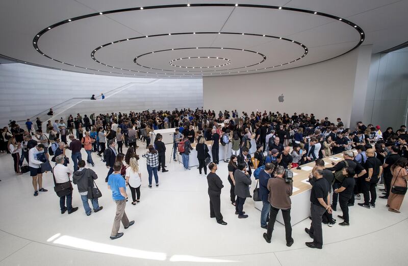 Attendees browse new products on display during an Apple Inc. event at the Steve Jobs Theater in Cupertino, California, U.S., on Wednesday, Sept. 12, 2018. Apple Inc. took the wraps off a renewed iPhone strategy on Wednesday, debuting a trio of phones that aim to spread the company's latest technology to a broader audience. Photographer: David Paul Morris/Bloomberg