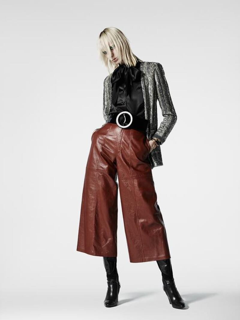 Leather culottes reminiscent of the 1970s and a black satin pussy-bow blouse are updated with an oversized belt and a fitted skinny jacket. Courtesy Saint Laurent