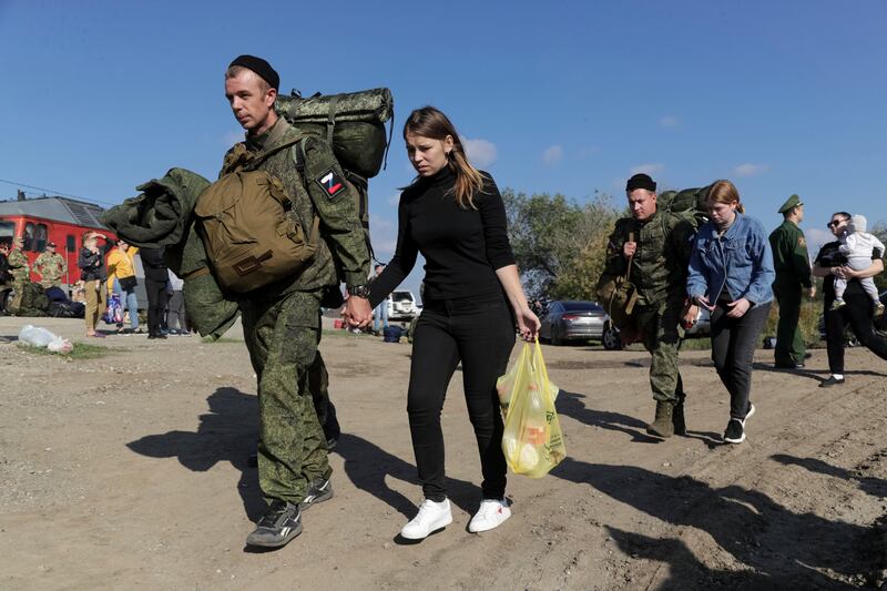 In what may be a final farewell, young Russian recruits - escorted by their wives - walk to a train station in Volgograd before being sent to war in Ukraine. AP
