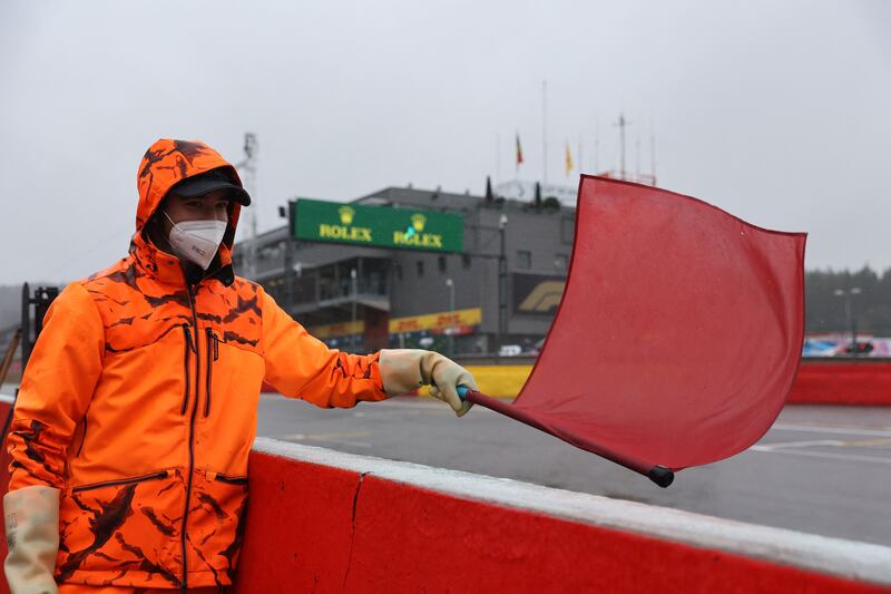 A race marshall waves the red flag as the race is postponed. AFP