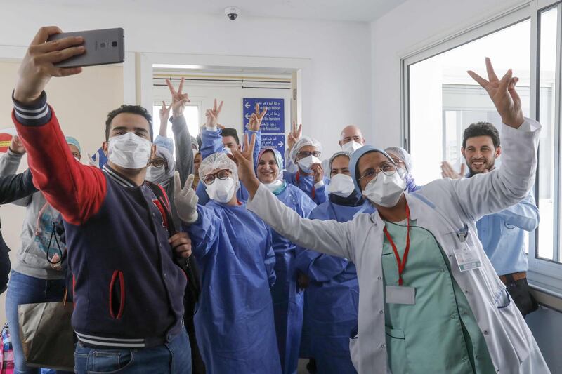 Moroccan patients who recovered from the coronavirus disease celebrate with the medical staff as they leave the hospital in the city of Sale, north of the capital Rabat. AFP