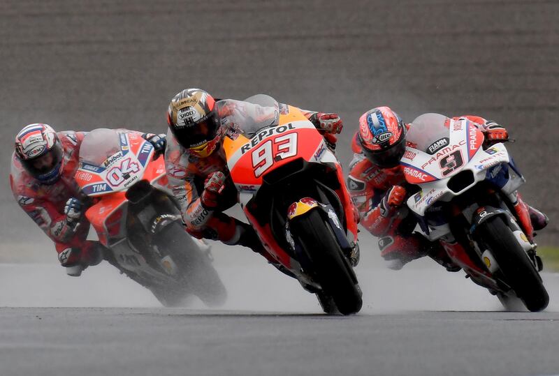 Honda rider Marc Marquez of Spain (C) leads Ducati rider Andrea Dovizioso of Italy (L) and Ducati rider Danilo Petrucci of Italy (R) during the MotoGP Japanese Grand Prix at Twin Ring Motegi circuit in Motegi, Tochigi prefecture on October 15, 2017. / AFP PHOTO / TOSHIFUMI KITAMURA