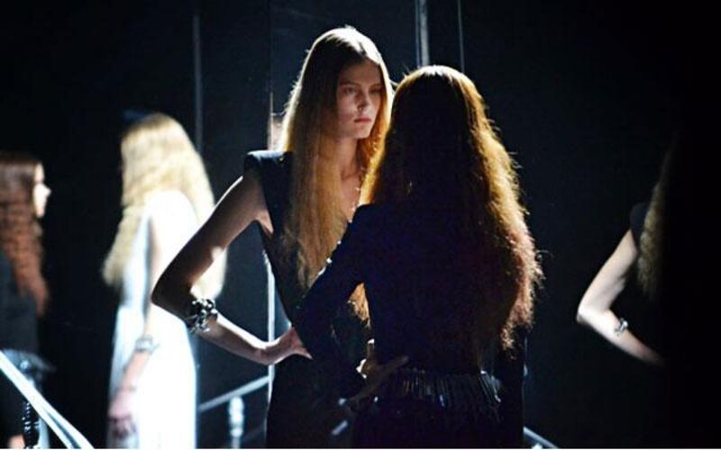 The show started with models standing in a mirrored box, waiting to walk the runway.