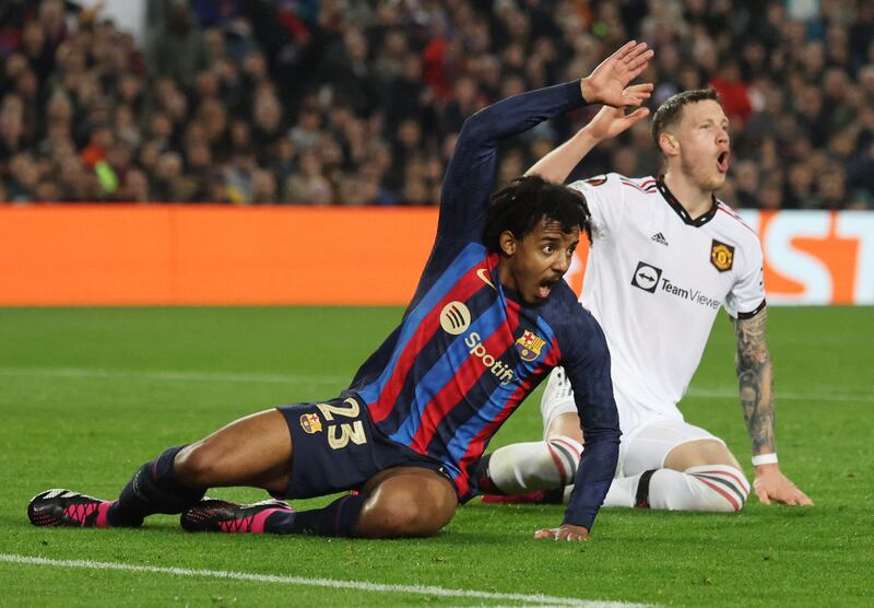 United's Wout Weghorst with Barcelona's Jules Kounde. Reuters