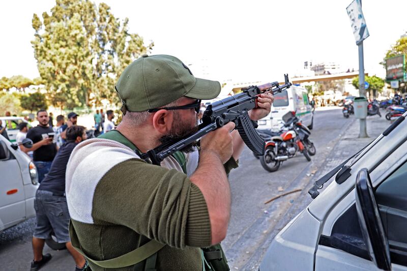 A fighter from the Amal movement takes aim during the armed clashes in Tayouneh.  AFP