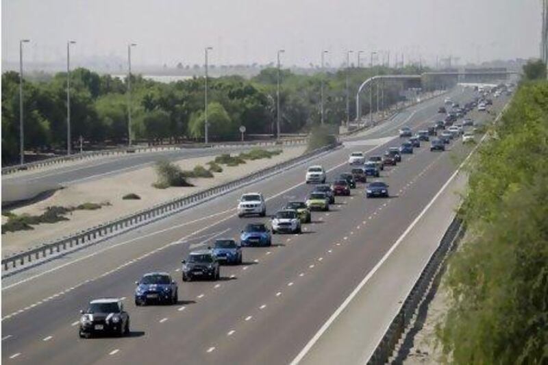 Minis from around the GCC travel in convoy along Sheikh Zayed Road before gathering at Dubai Autodrome.