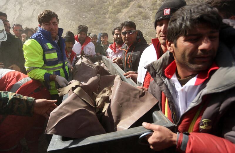 Members of the Iranian Red Crescent carry a body recovered from the wreckage of the prrivate jet which crashed in the mountains around the city of Shahr-e Kord, Iran. Morteza Salehi / EPA