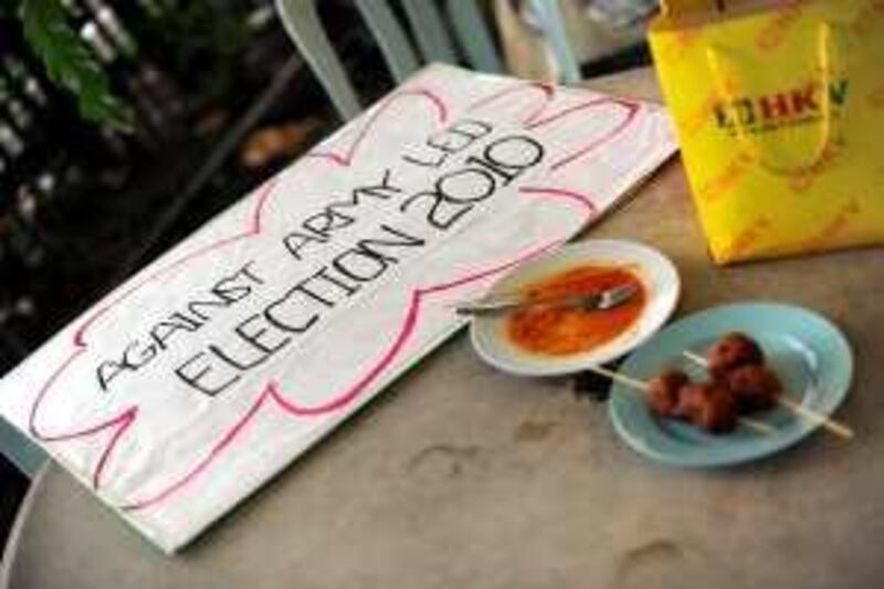 A placard carrying the message "Against army led election 2010," referring to upcoming elections in Military-run Myanmar, sits on a restaraunt table after a brief silent protest in support of detained pro-democracy leader Aung San Suu Kyi in front of the Myanmar embassy in Kuala Lumpur on August 12, 2009. The Association of Southeast Asian Nations (ASEAN) expressed deep disappointment over the conviction of Aung San Suu Kyi. A Myanmar court convicted the 64-year-old opposition leader at the end of a marathon trial for breaching the terms of her detention by the ruling military junta, following a bizarre incident in which an American man swam uninvited to her home. AFP PHOTO / Saeed KHAN