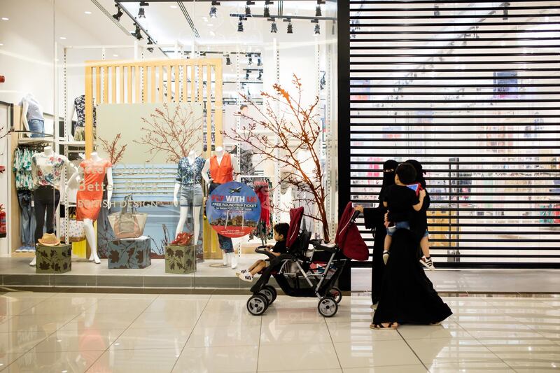 Women and children pass the shuttered entrance to a closed store during prayer time at the Al Yasmin mall in Jeddah, Saudi Arabia, on Sunday, Aug. 6, 2017. After relying on oil to fuel its economy for more than half a century, Saudi Arabia is turning to its other abundant natural resource to take it beyond the oil age -- desert. Photographer: Tasneem Alsultan/Bloomberg