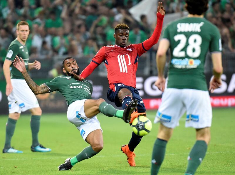 Saint-Etienne's French defender Yann M'Vila (L) vies with Lille's Malian midfielder Yves Bissouma (R) during the French L1 football match Saint-Etienne (ASSE) vs Lille (LOSC) on May 19, 2018, at the Geoffroy Guichard Stadium in Saint-Etienne, central France. / AFP PHOTO / JEAN-PHILIPPE KSIAZEK