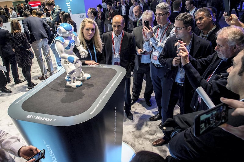 BARCELONA, SPAIN - FEBRUARY 24:  Visitors attend a demonstration of a robot named 'Watson' at the IBM stand on  day 3 of the Mobile World Congress 2016 on February 24, 2016 in Barcelona, Spain.The annual Mobile World Congress hosts some of the world's largest communications companies, with many unveiling their latest phones and wearables gadgets.  (Photo by David Ramos/Getty Images)