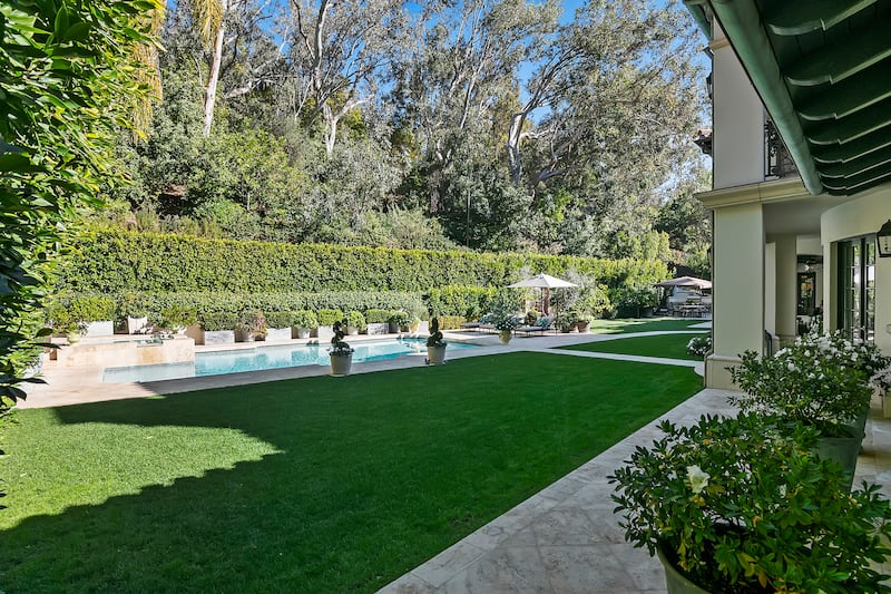 Manicured lawns encircle the outdoor swimming pool. Photo: Sotheby’s International Realty 