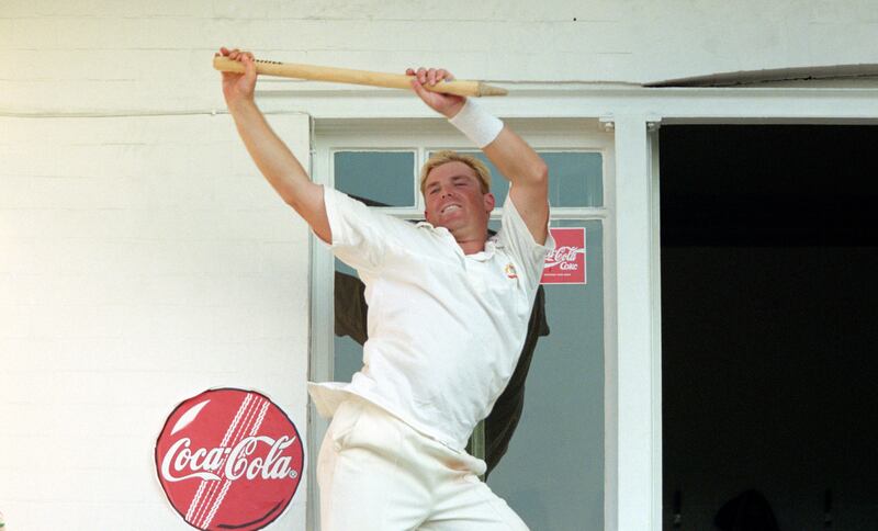 Shane Warne celebrates by dancing with a stump on the dressing room balcony after victory over England in the Fifth Ashes test match at Trent Bridge in 1997. Getty Images