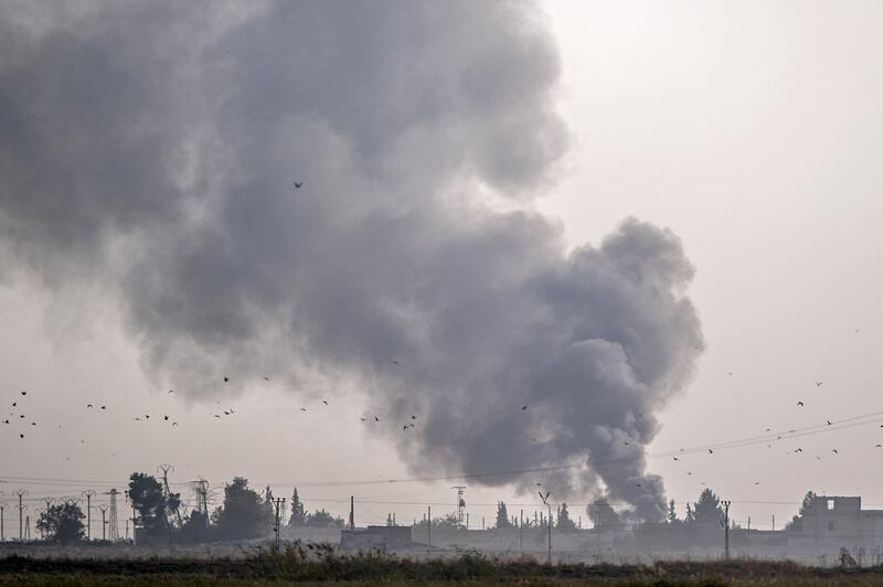 Smoke rises from the Syrian town of Tal Abyad after Turkish bombings, in a picture taken from the Turkish side of the border near Akcakale in the Sanliurfa province. AFP