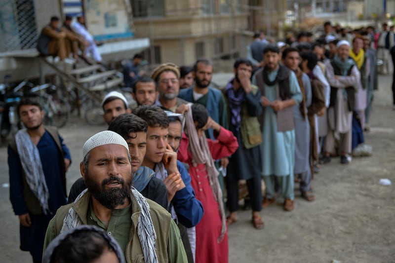 Afghans wait for the banks to open in Kabul on August 31, 2021. AFP