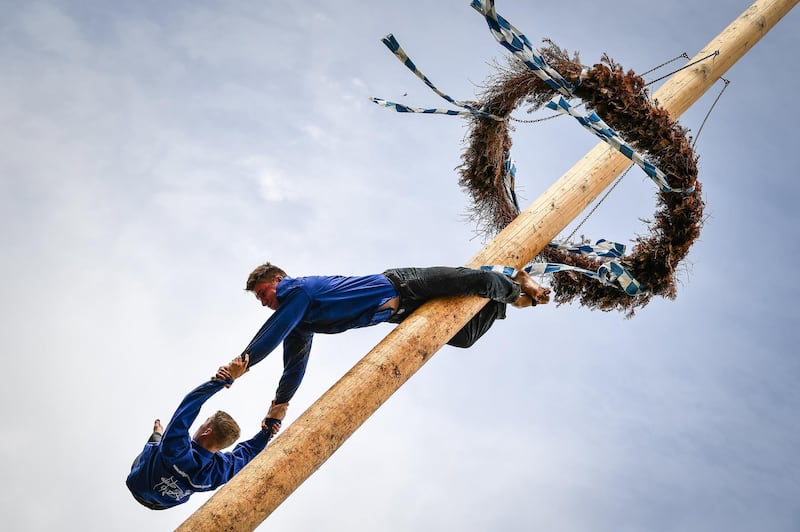 Competitors perform acrobatics on the maypole in Rottenstuben, Germany. EPA
