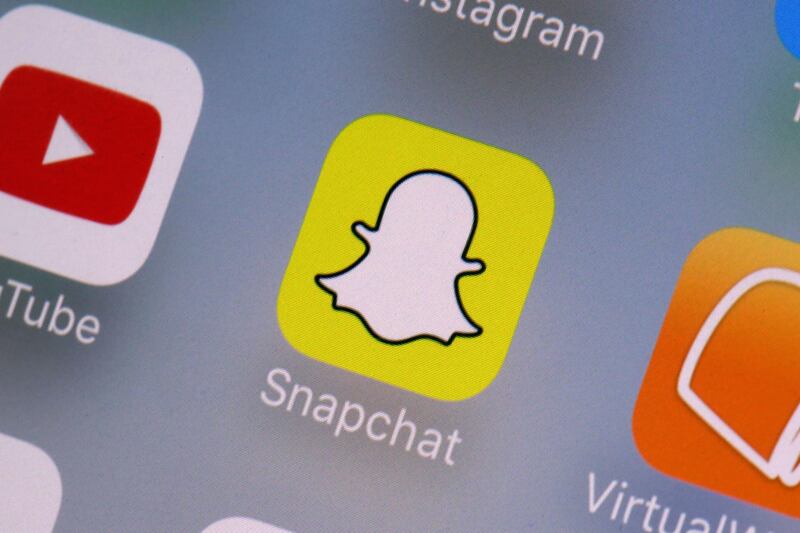 This Wednesday, Aug. 9, 2017, photo shows the Snapchat app on a mobile device in New York. Snap Inc. reports earnings Tuesday, Feb. 6, 2018. (AP Photo/Richard Drew)