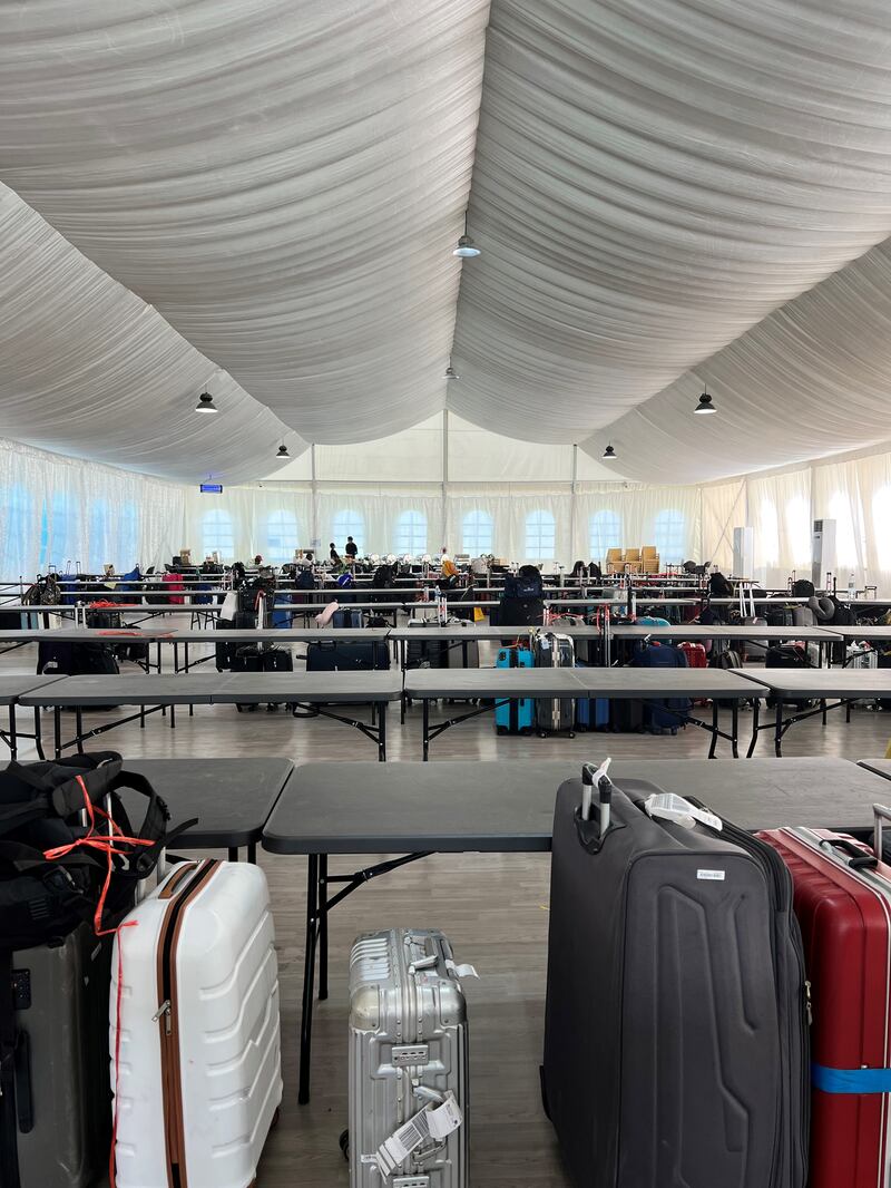 Large tents have been transformed into baggage holding centres for those arriving prior to check-in time