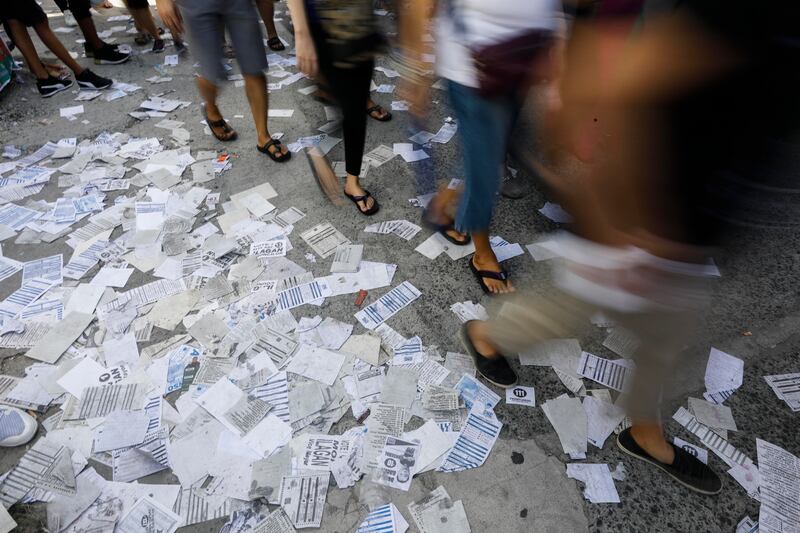 Flyers resembling sample ballots are scattered at a school used as a voting centre in the Cainta town of Rizal province. EPA