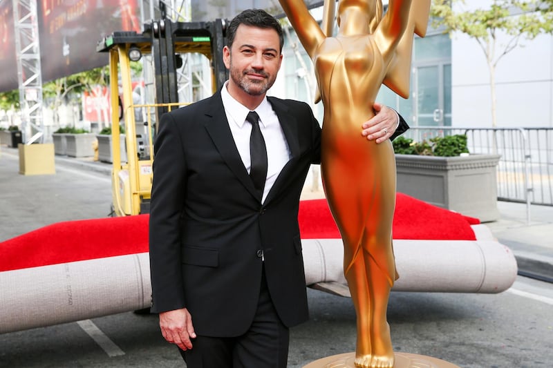 FILE - This Sept. 14, 2016 file photo shows host Jimmy Kimmel posing for a photo with a replica of an Emmy statue at the Primetime Emmy Awards Press Preview Day in Los Angeles. Kimmel will return as host and will serve as executive producer for the 72nd Emmy Awards. The show will be broadcast, Sunday, Sept. 20, on ABC. (Photo by Rich Fury/Invision/AP, File)