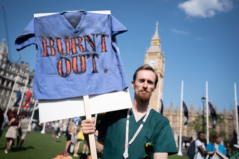 A striking junior doctor takes part in a rally in Parliament Square, central London, during a 72-hour stoppage in a row with the government over pay. PA