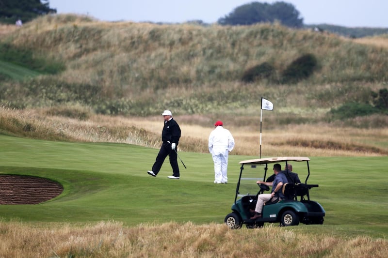 FILE - In this Saturday, July 14, 2018, file photo, U.S. President Donald Trump walks off the 4th green while playing at Turnberry golf club, in Turnberry, Scotland. A financial report filed with the British government shows that Trump lost millions of dollars at his flagship Scottish golf resort for a fourth year in a row in 2017. (AP Photo/Peter Morrison, File)