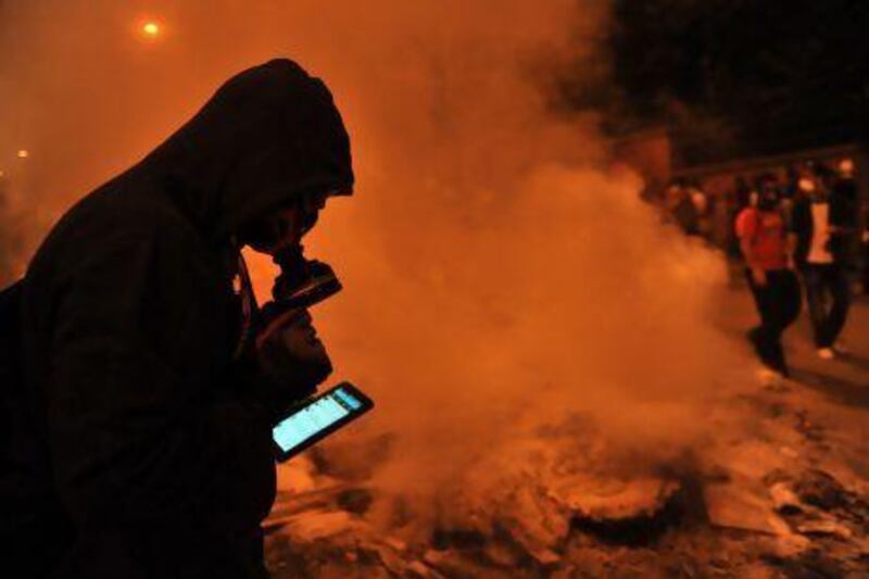 A protester in Istanbul uses Facebook on mobile phone to give latest news about the clashes near Taksim this week.