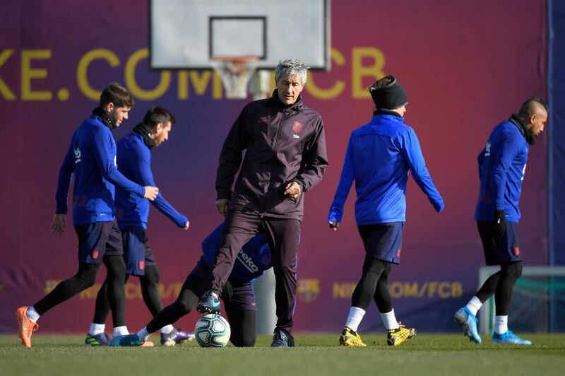 Barcelona manager Quique Setien (C), attends a training session at Joan Gamper Sports City. AFP