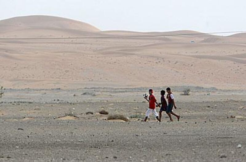 Children walking in the village of Nahel, one of several small and isolated communities in the thinly populated Eastern Region.