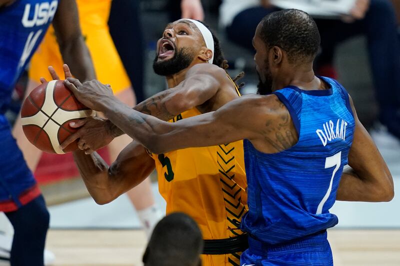 Patty Mills, who top-scored for Australia, drives to the basket against USA's Kevin Durant. AP
