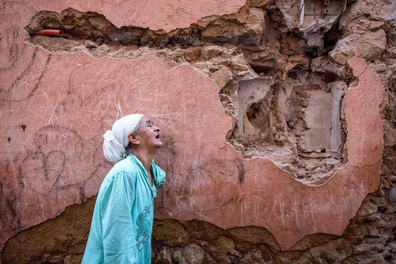 A woman stands outside her house in Marrakesh, damaged during the earthquake on Friday night that killed more than 600 people. AFP