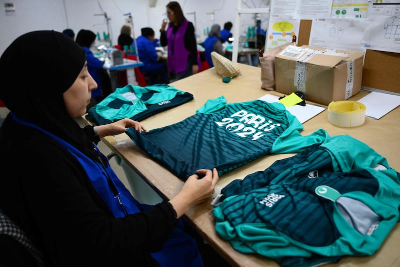 Employees work on outfits for volunteers at a manufacturing workshop in Marseille. AFP