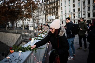 Local residents pay tributes to an Iranian man, Mohammad Moradi, 38, who killed himself after jumping into the Rhone river to raise awareness about the situation of the Iranian people, in the French city of Lyon, on December 27, 2022. AFP