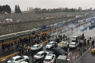 People stop their cars on a road in Tehran, Iran, on November 16, 2019, in protest against fuel price rises. Wana