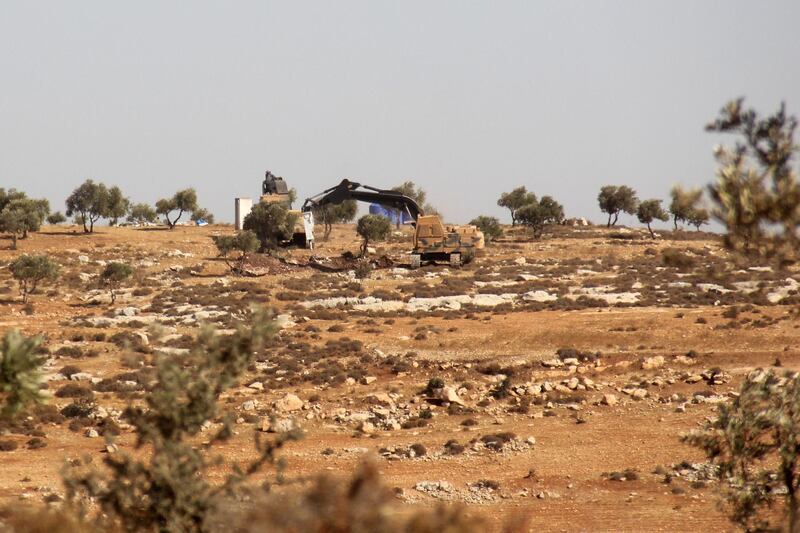 A picture taken on October 14, 2017, shows Turkish army diggers on a hill in the Syrian border town of Salwah.
Turkish forces have entered northwest Syria's largely jihadist-controlled Idlib province, observers said, where Ankara said this week it planned to create a "de-escalation zone" as part of efforts to end the Syrian war. / AFP PHOTO / Omar haj kadour