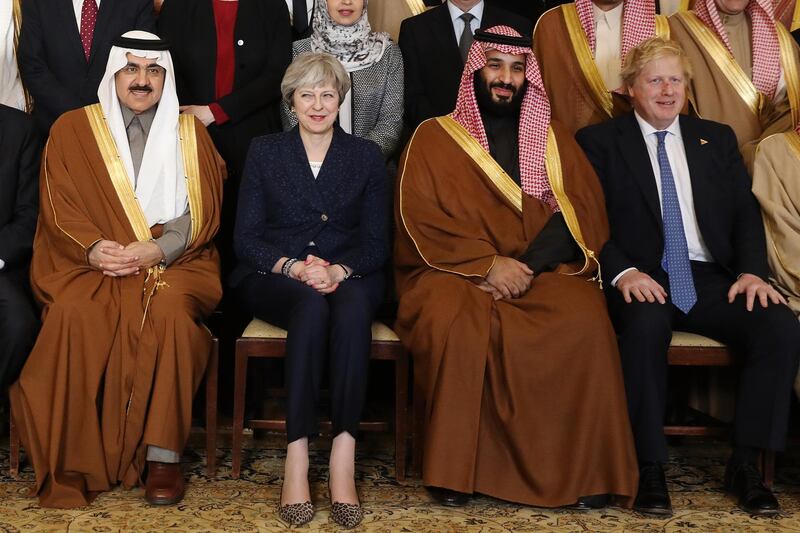 Prince Mohammed poses for a photograph with members of the British government and Saudi ministers and delegates. Getty Images